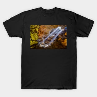 Sun rays shine through ceiling hole in Dau Go cave in Halong Bay, Vietnam T-Shirt